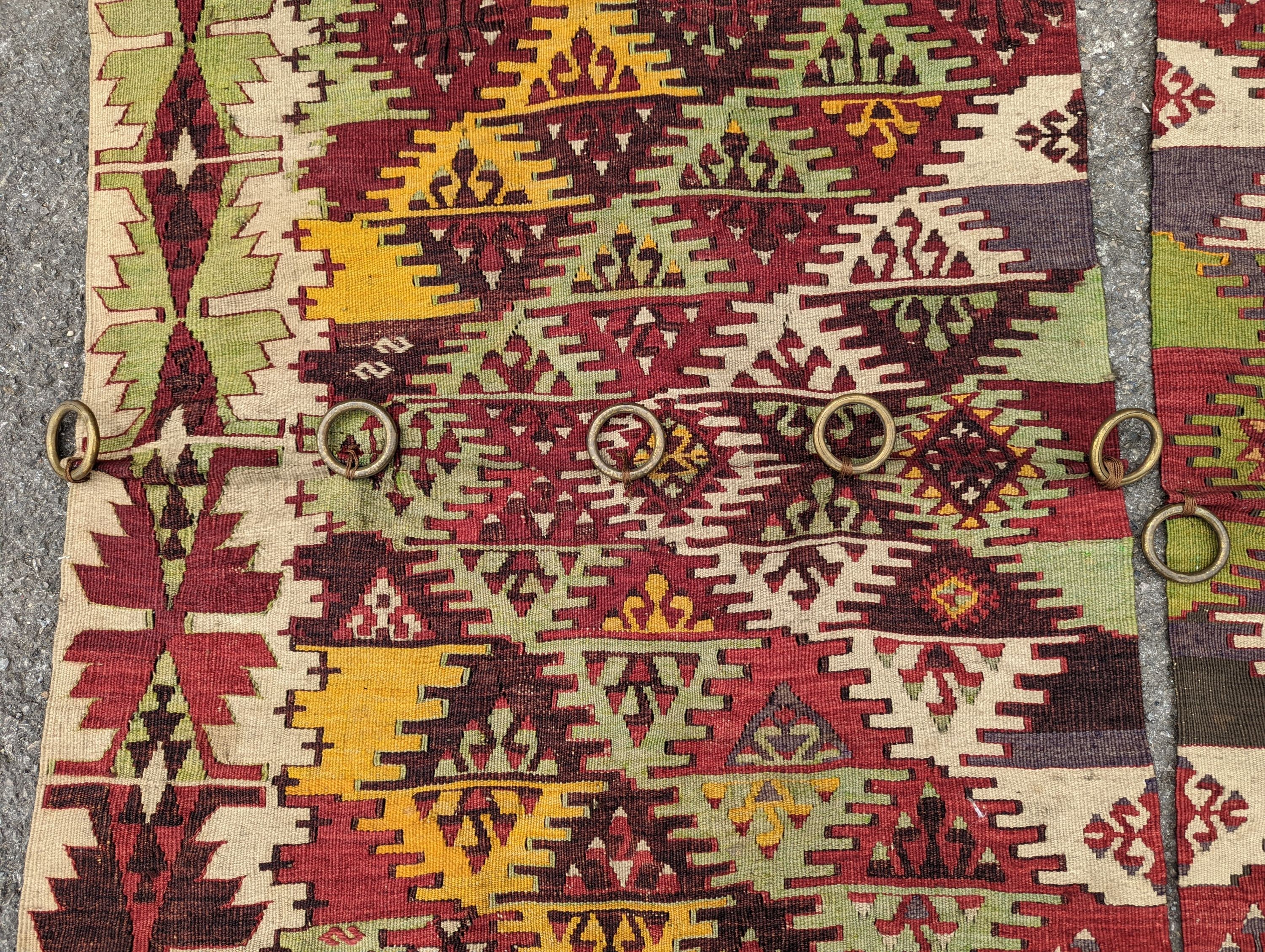 A Kelim polychrome flatweave carpet, cut centrally to create a pair of runners, each 410 x 85cm